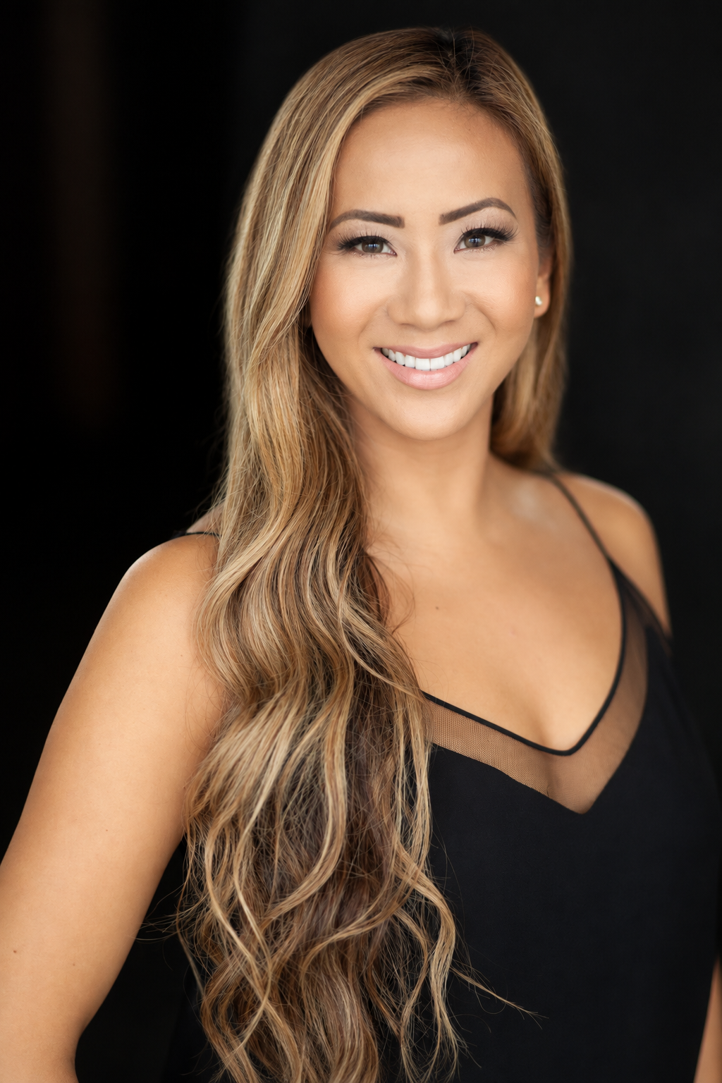 Stephanie Sy studio headshot in black